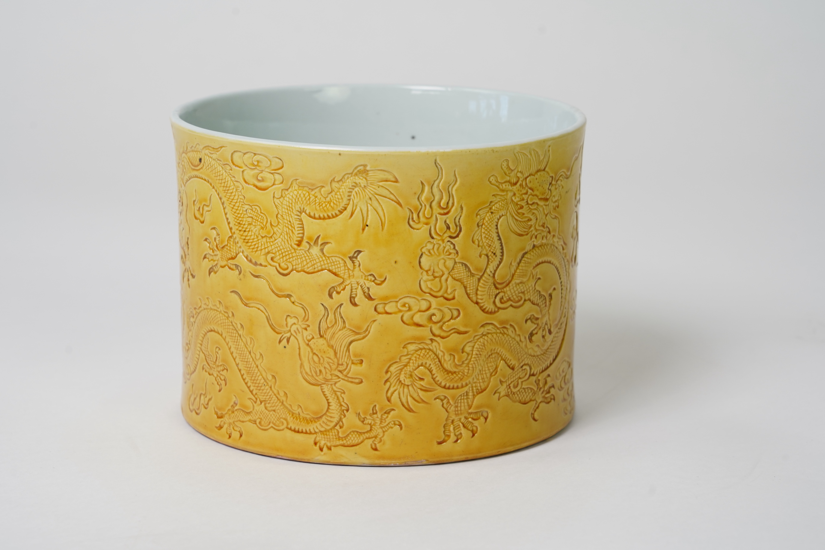 A Chinese yellow glazed 'dragon' brush pot, possibly Republic period